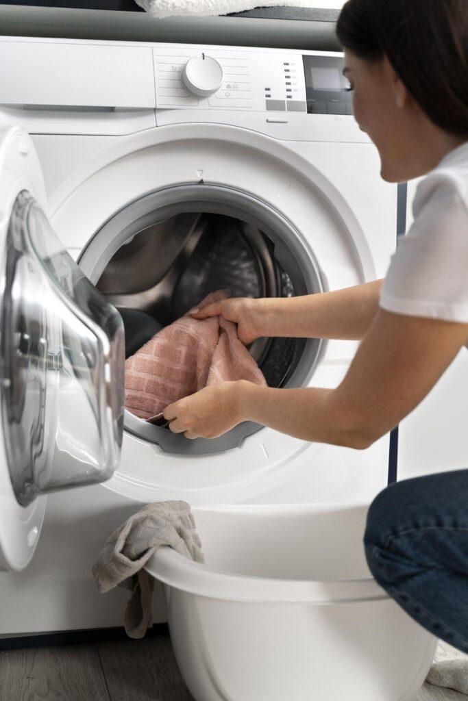 woman-taking-clothes-from-washing-machine